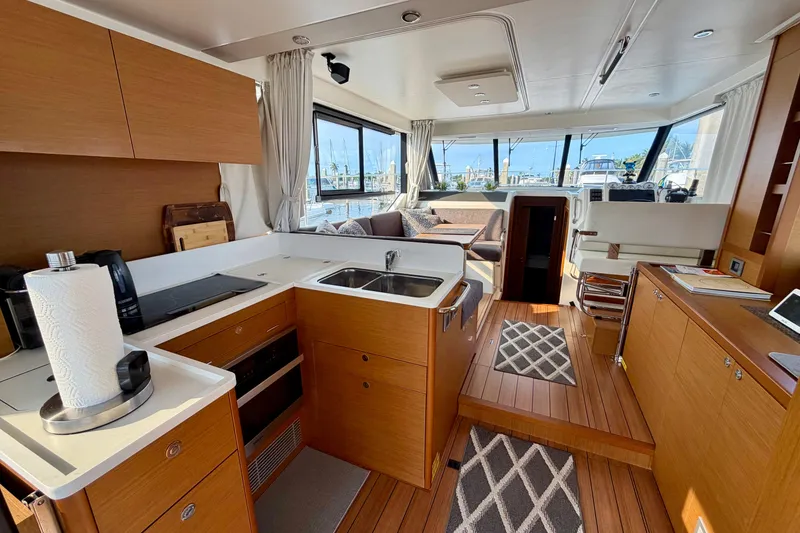 Slide: The Image of Interior of 2021 Beneteau Swift Trawler 41 Fly, featuring modern kitchen and seating area. - 24