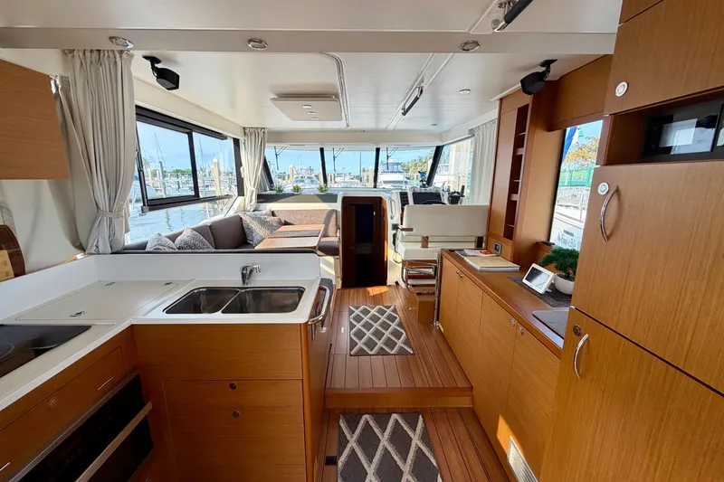 Slide: The Image of Luxurious interior of 2021 Beneteau Swift Trawler 41 Fly with modern kitchen and seating area. - 25