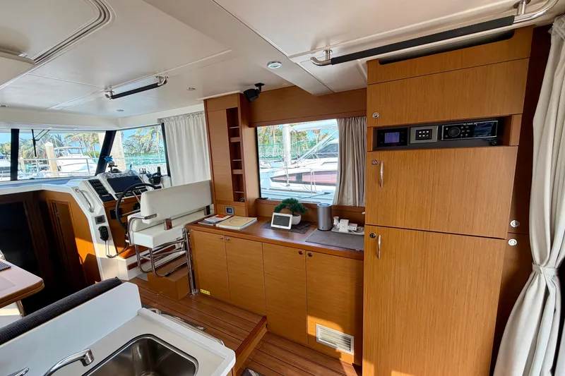 Slide: The Image of Interior of 2021 Beneteau Swift Trawler 41 Fly, featuring helm and wooden cabinetry. - 27