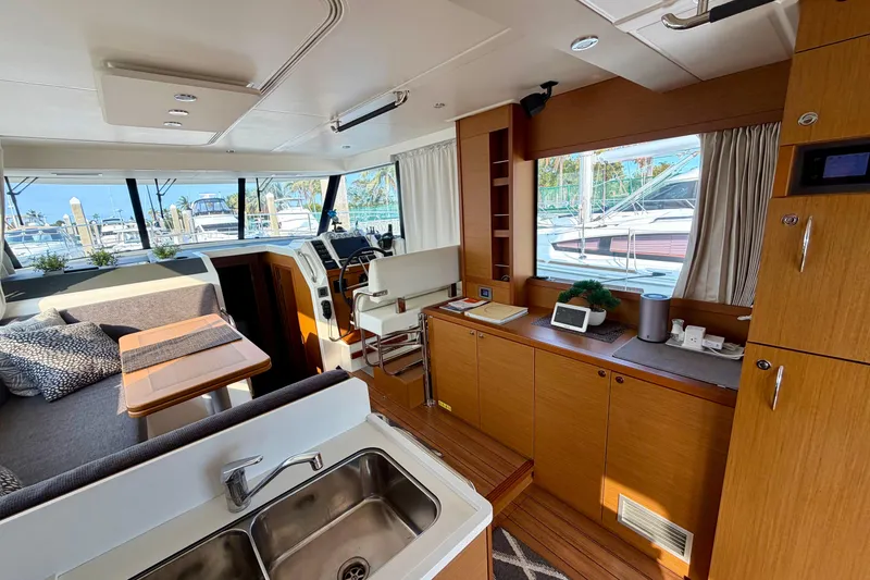 Slide: The Image of Interior of 2021 Beneteau Swift Trawler 41 Fly, featuring modern kitchen and seating area. - 28