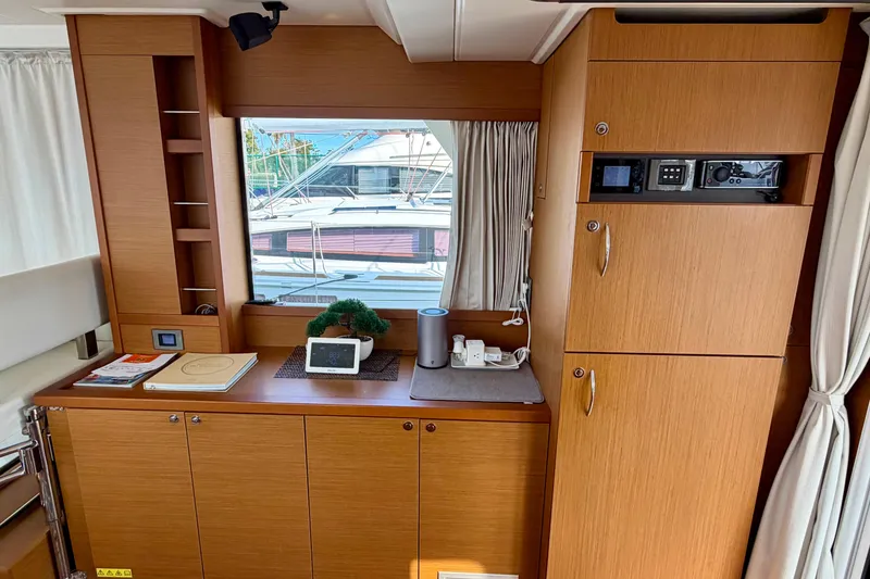 Slide: The Image of Interior of 2021 Beneteau Swift Trawler 41 Fly with wooden cabinetry and window view. - 29