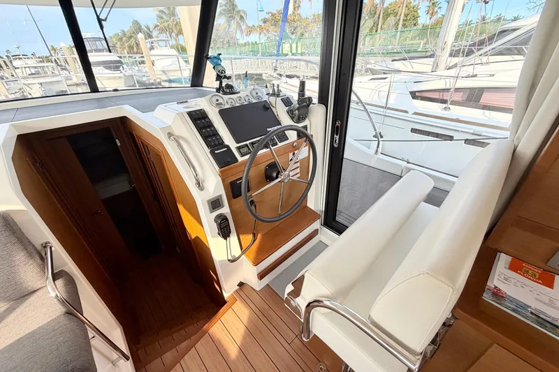 Slide: The Image of Interior helm station of 2021 Beneteau Swift Trawler 41 Fly, featuring modern controls and seating. - 34