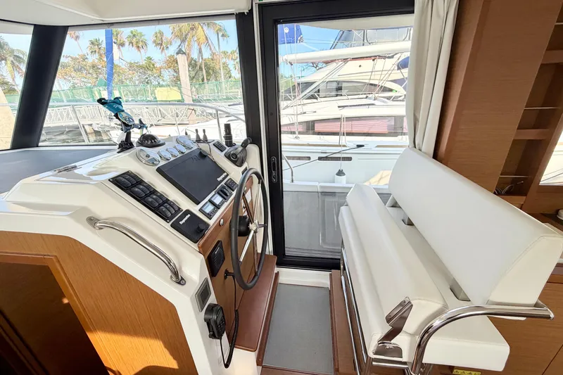 Slide: The Image of Interior helm of 2021 Beneteau Swift Trawler 41 Fly with modern controls and seating. - 35