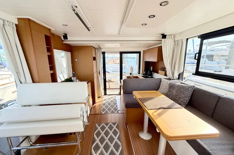 Slide: The Image of Interior of 2021 Beneteau Swift Trawler 41 Fly, featuring modern seating and dining area. - 38