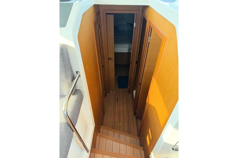 Slide: The Image of Interior view of 2021 Beneteau Swift Trawler 41 Fly, featuring wooden stairs and cabin entrance. - 39