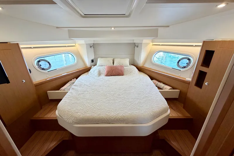 Slide: The Image of Luxurious cabin interior of 2021 Beneteau Swift Trawler 41 Fly with cozy bed and porthole windows. - 40