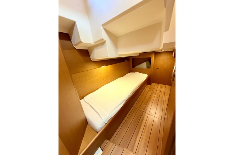 Slide: The Image of 2021 Beneteau Swift Trawler 41 Fly cabin with wooden interior and single bed. - 46