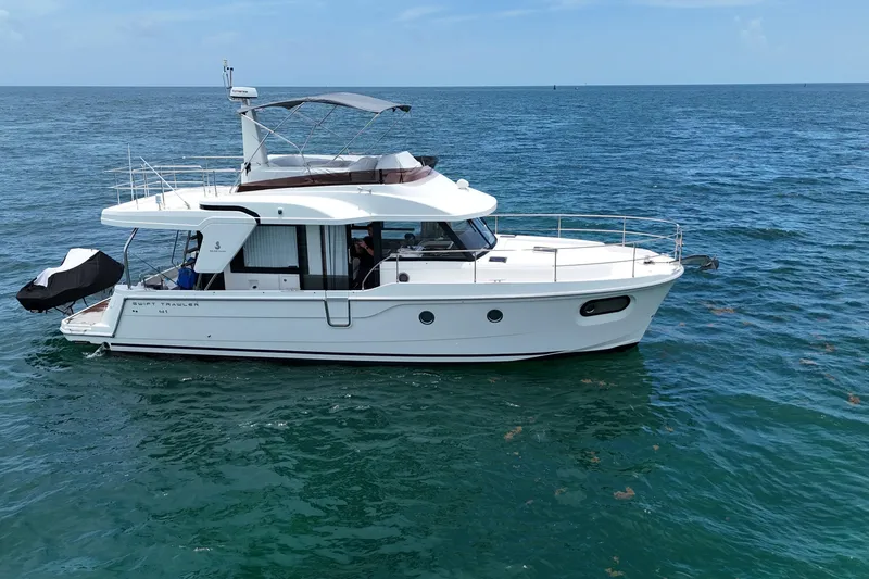 Slide: The Image of 2021 Beneteau Swift Trawler 41 Fly cruising on open sea under clear skies. - 5