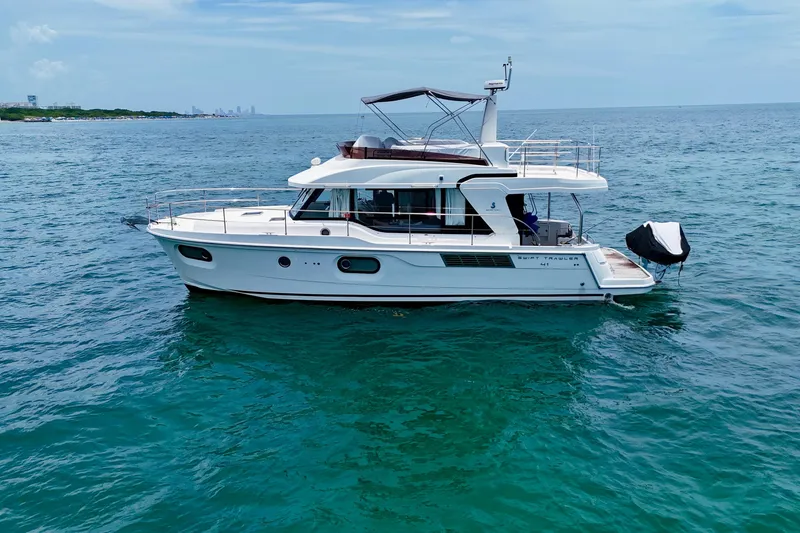 Slide: The Image of 2021 Beneteau Swift Trawler 41 Fly cruising on open sea under clear skies. - 8