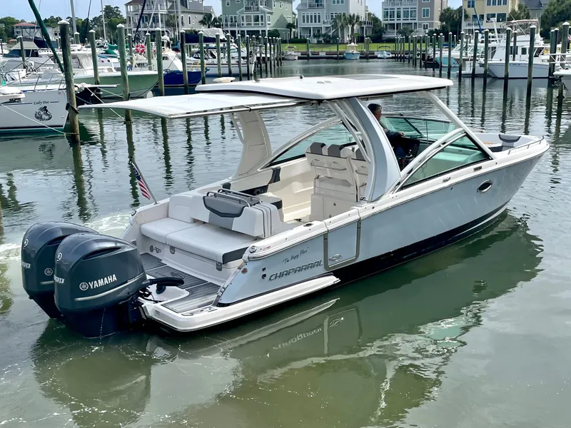 Slide: The Image of 2021 Chaparral 300 OSX boat docked with Yamaha engines. - 10