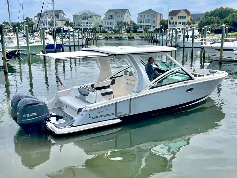 Slide: The Image of 2021 Chaparral 300 OSX boat docked with Yamaha engines. - 11