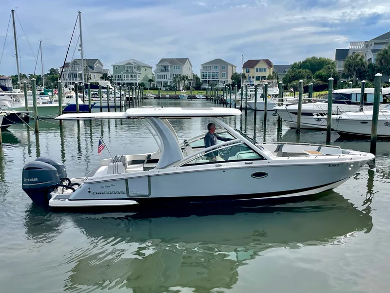 Slide: The Image of 2021 Chaparral 300 OSX boat in harbor, side view. - 12