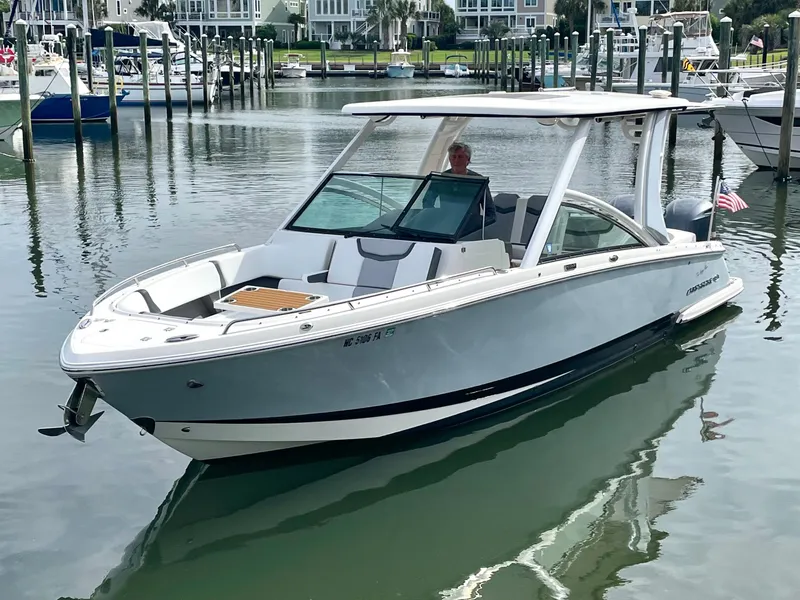 Slide: The Image of 2021 Chaparral 300 OSX boat in harbor, modern design. - 2