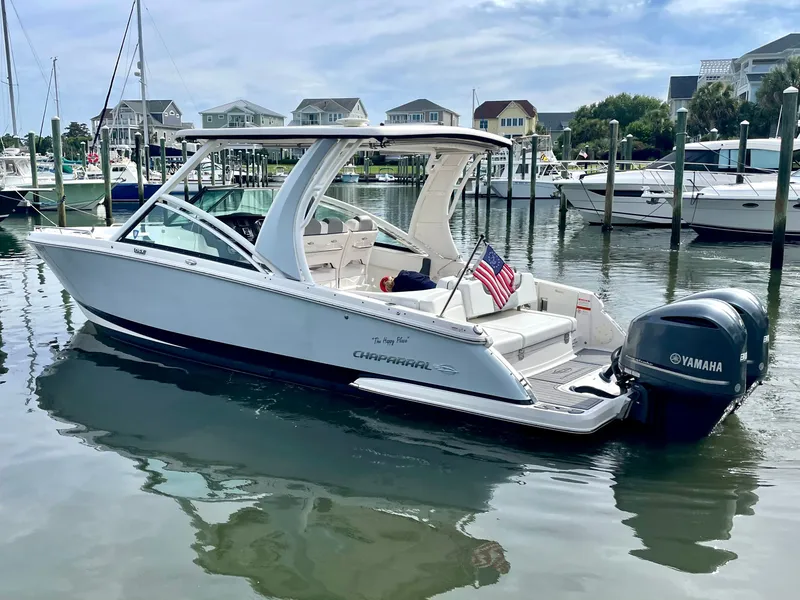 Slide: The Image of 2021 Chaparral 300 OSX boat docked with Yamaha engines. - 21