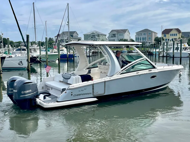 Slide: The Image of 2021 Chaparral 300 OSX boat docked with Yamaha engines. - 24