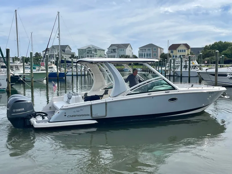 Slide: The Image of 2021 Chaparral 300 OSX boat docked in harbor with Yamaha engine. - 25