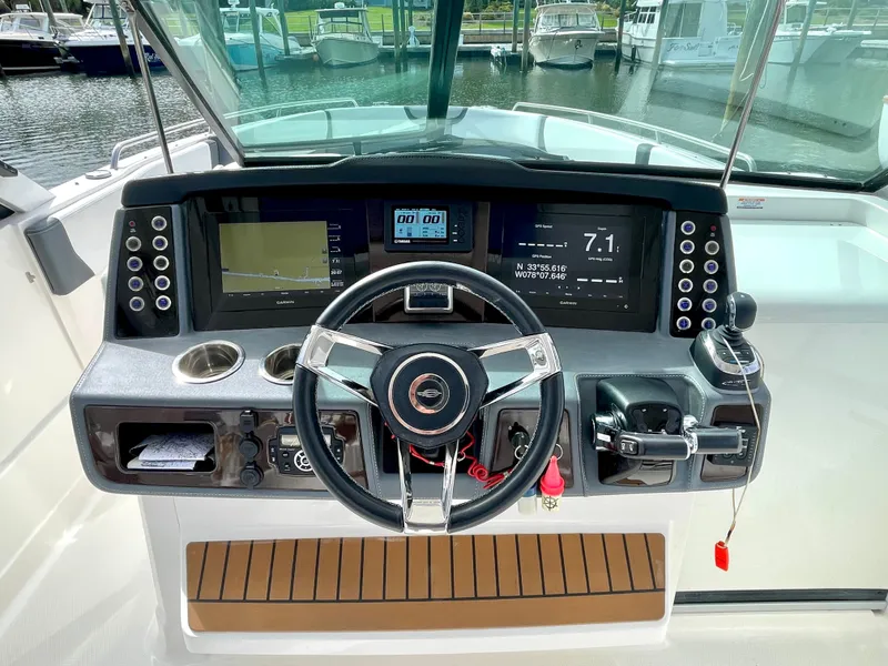 Slide: The Image of 2021 Chaparral 300 OSX helm with modern navigation instruments. - 28