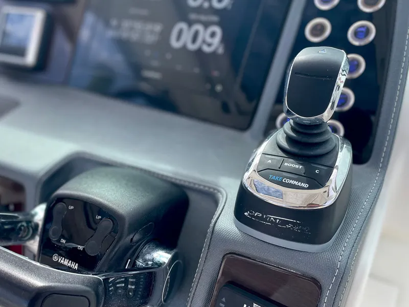 Slide: The Image of Close-up of control lever on a 2021 Chaparral 300 OSX boat. - 30