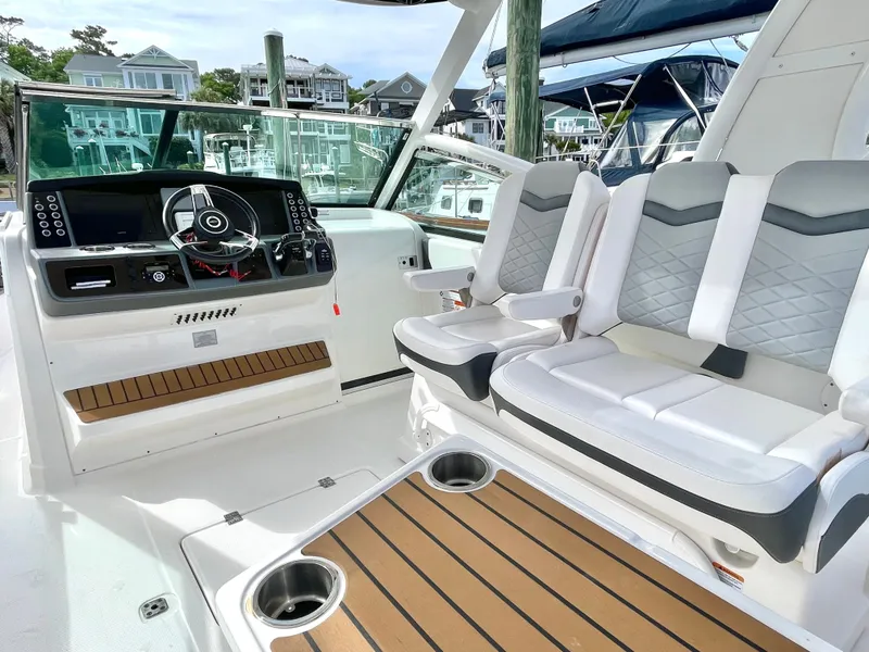 Slide: The Image of Interior of 2021 Chaparral 300 OSX with helm and seating. - 35