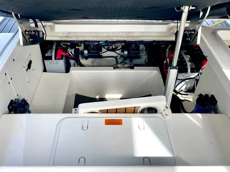 Slide: The Image of Interior of 2021 Chaparral 300 OSX showing batteries and equipment. - 43