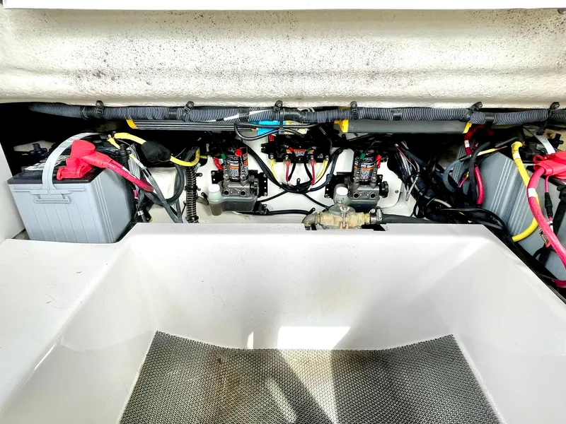 Slide: The Image of Engine compartment of 2021 Chaparral 300 OSX with wiring and batteries. - 44