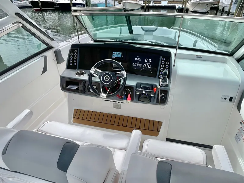 Slide: The Image of Interior view of 2021 Chaparral 300 OSX boat cockpit. - 47