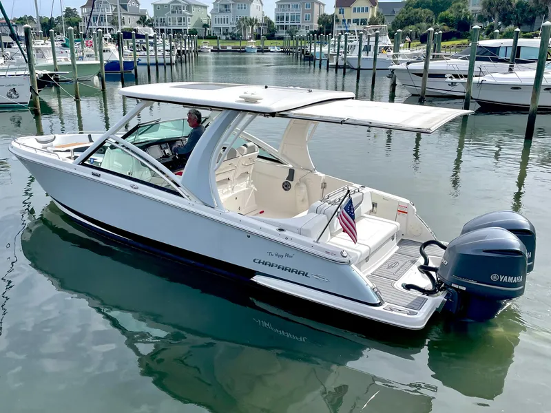 Slide: The Image of Chaparral 300 OSX 2021 boat docked in harbor with outboard engines. - 6