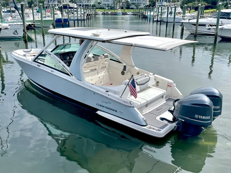 Slide: The Image of 2021 Chaparral 300 OSX boat docked with Yamaha engines. - 7