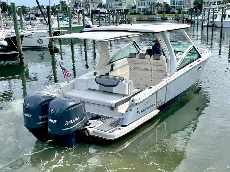 Slide: The Image of 2021 Chaparral 300 OSX boat docked with Yamaha engines. - 9