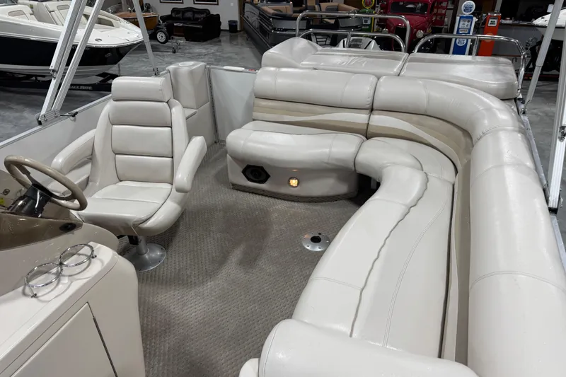 Slide: The Image of Interior of a 2005 Crest 25 Savanna boat with plush seating and steering console. - 10