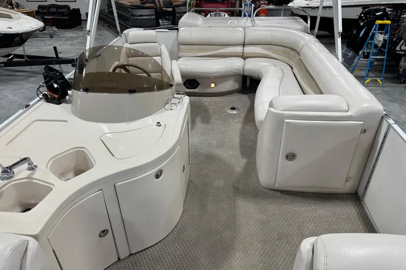 Slide: The Image of 2005 Crest 25 Savanna pontoon boat interior with plush seating and helm station. - 11