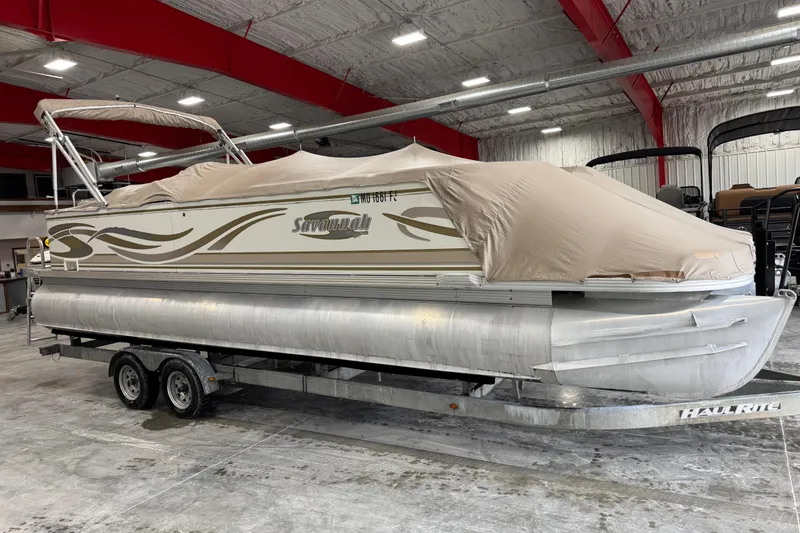 Slide: The Image of Covered 2005 Crest 25 Savanna pontoon boat on trailer in indoor storage facility. - 14