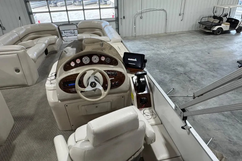 Slide: The Image of Interior view of a 2005 Crest 25 Savanna boat with steering console and seating. - 8