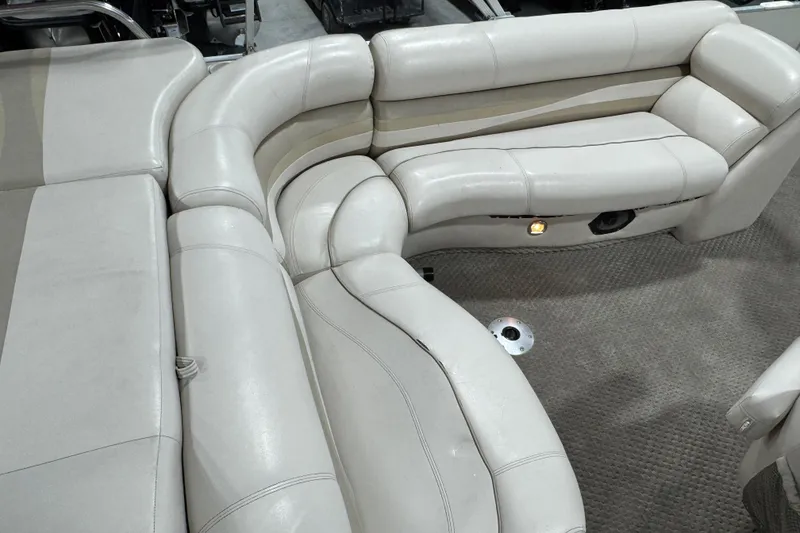 Slide: The Image of Luxurious seating on a 2005 Crest 25 Savanna pontoon boat, featuring plush, curved upholstery. - 9