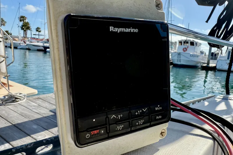 Slide: The Image of Raymarine navigation system on 1985 Catalina 38 sailboat, docked at marina with boats in background. - 13