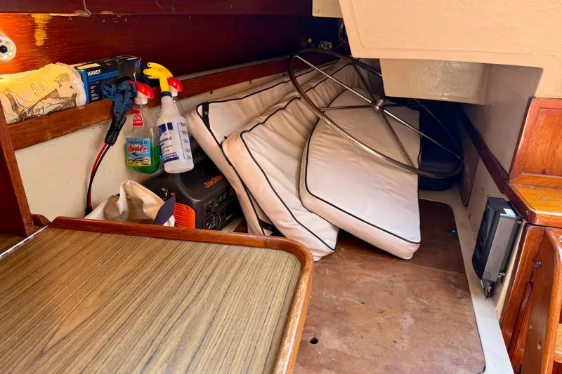 Slide: The Image of Interior of a 1985 Catalina 38 sailboat with cushions and cleaning supplies. - 20