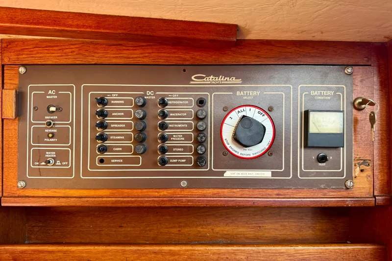 Slide: The Image of Electrical control panel of a 1985 Catalina 38 yacht with AC/DC switches and battery selector. - 22