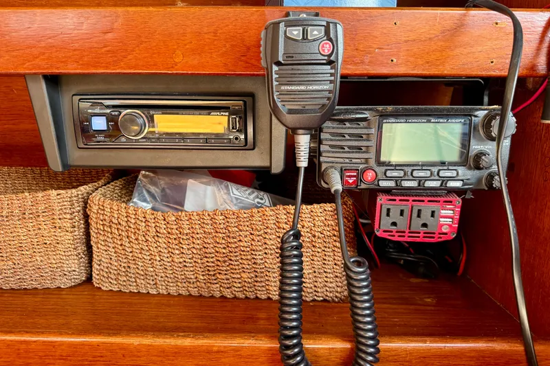 Slide: The Image of 1985 Catalina 38 yacht interior with radio equipment and woven storage baskets. - 23