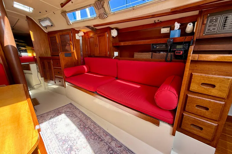 Slide: The Image of Interior of 1985 Catalina 38 sailboat with red cushions and wooden cabinetry. - 25