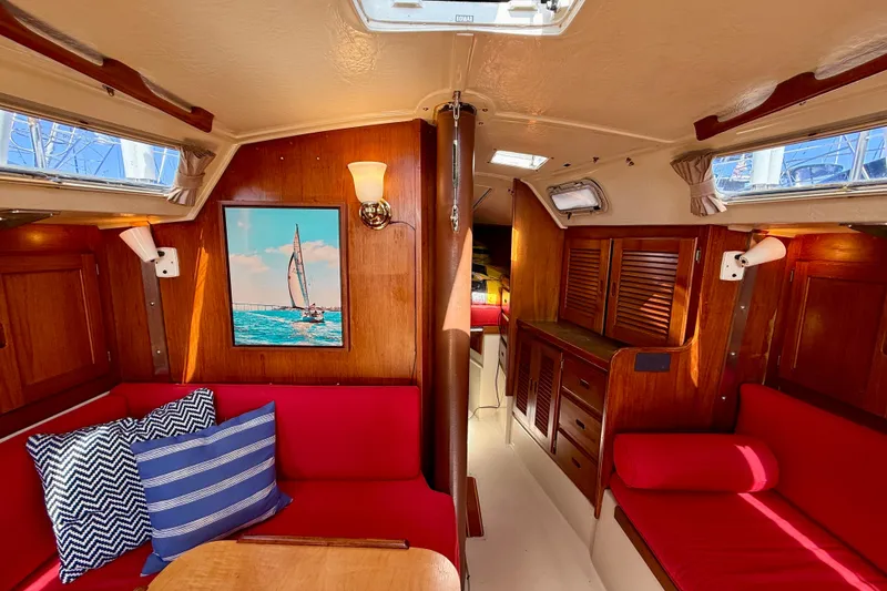 Slide: The Image of Interior of 1985 Catalina 38 sailboat with red seating and nautical decor. - 27