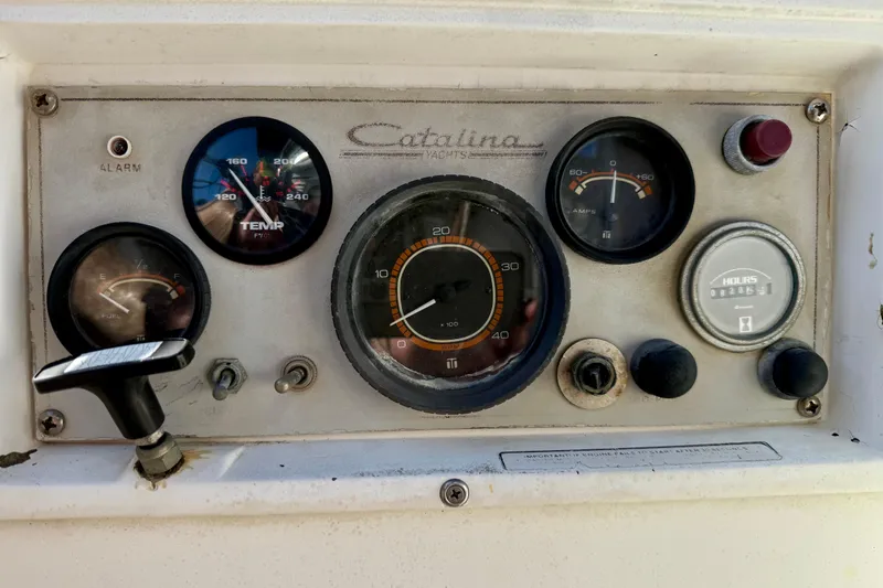 Slide: The Image of Control panel of a 1985 Catalina 38 yacht with gauges and switches. - 34