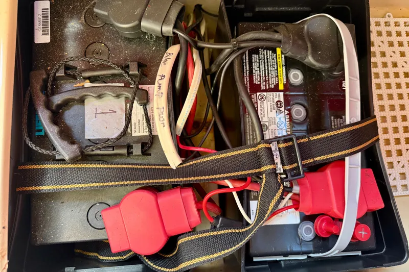 Slide: The Image of Battery compartment of a 1985 Catalina 38 sailboat with wiring and safety straps. - 35