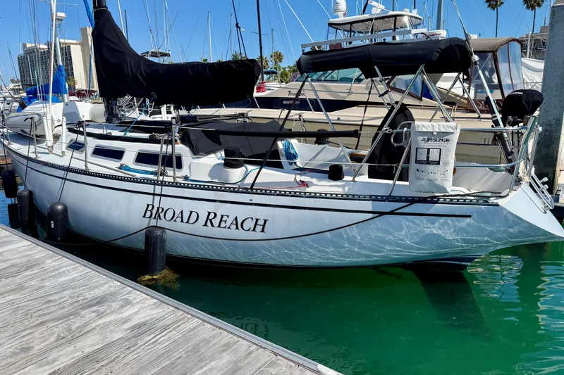 Slide: The Image of Catalina 38 sailboat named "Broad Reach" docked in a marina, 1985 model. - 4