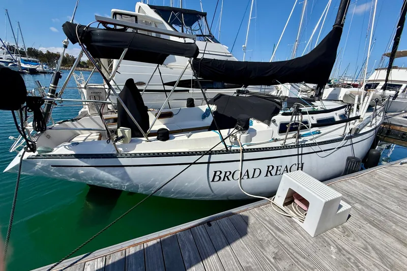 Slide: The Image of 1985 Catalina 38 sailboat named "Broad Reach" docked in a marina. - 5