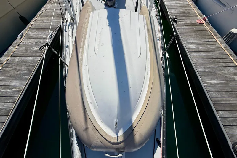 Slide: The Image of 1985 Catalina 38 sailboat docked between wooden piers, viewed from above. - 7