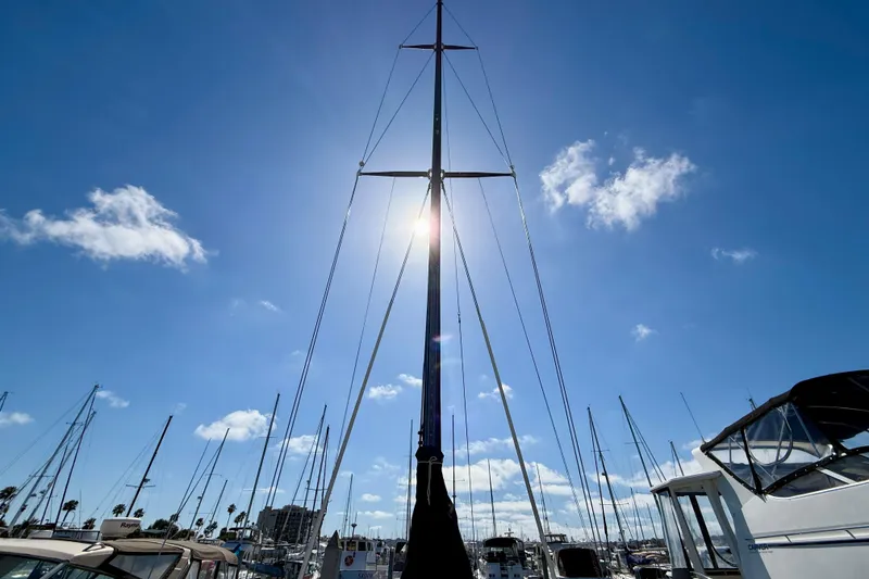 Slide: The Image of Sailboat mast of 1985 Catalina 38 against a bright blue sky with clouds. - 8