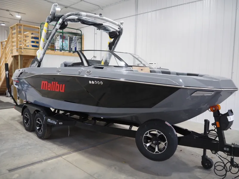 The Image of 2026 Malibu Wakesetter 21 LX boat in a garage on a trailer. - 1