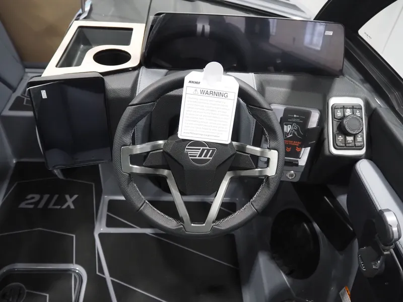 Slide: The Image of Interior of 2026 Malibu Wakesetter 21 LX with steering wheel and controls. - 13
