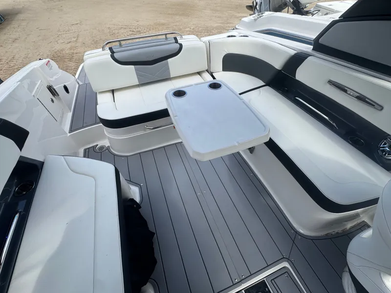 Slide: The Image of Interior of 2023 Chaparral 287 SSX with seating area and table. - 8