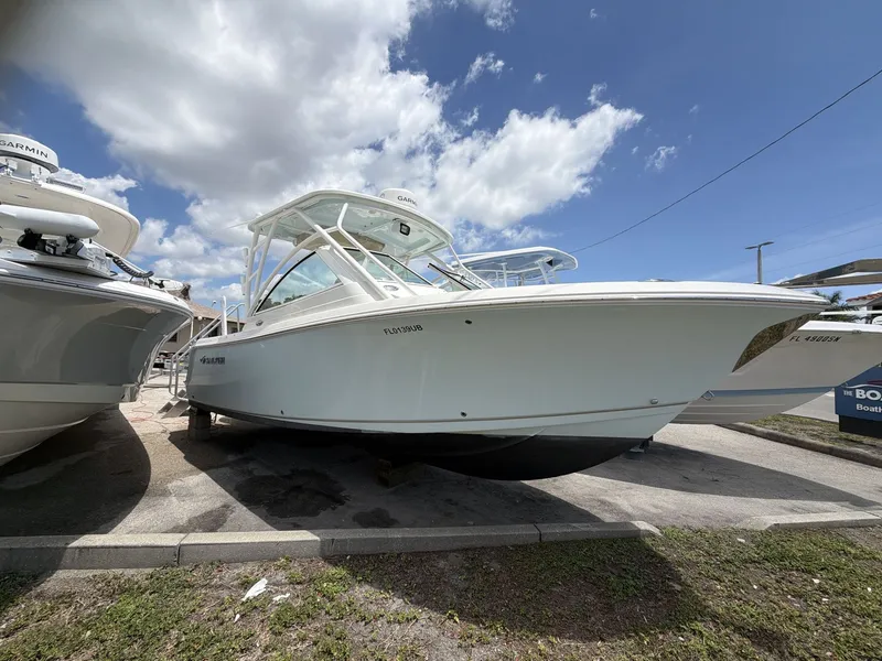 The Image of 2022 Sailfish 245 DC boat parked under a blue sky. - 1
